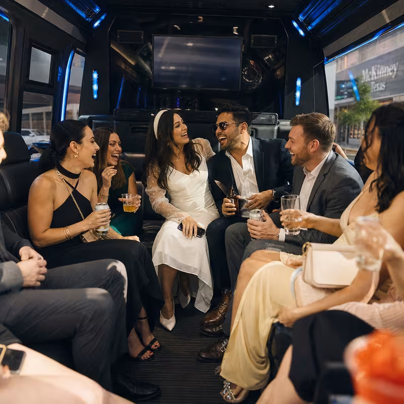 Party bus interior with wraparound leather seating and LED lighting in McKinney
