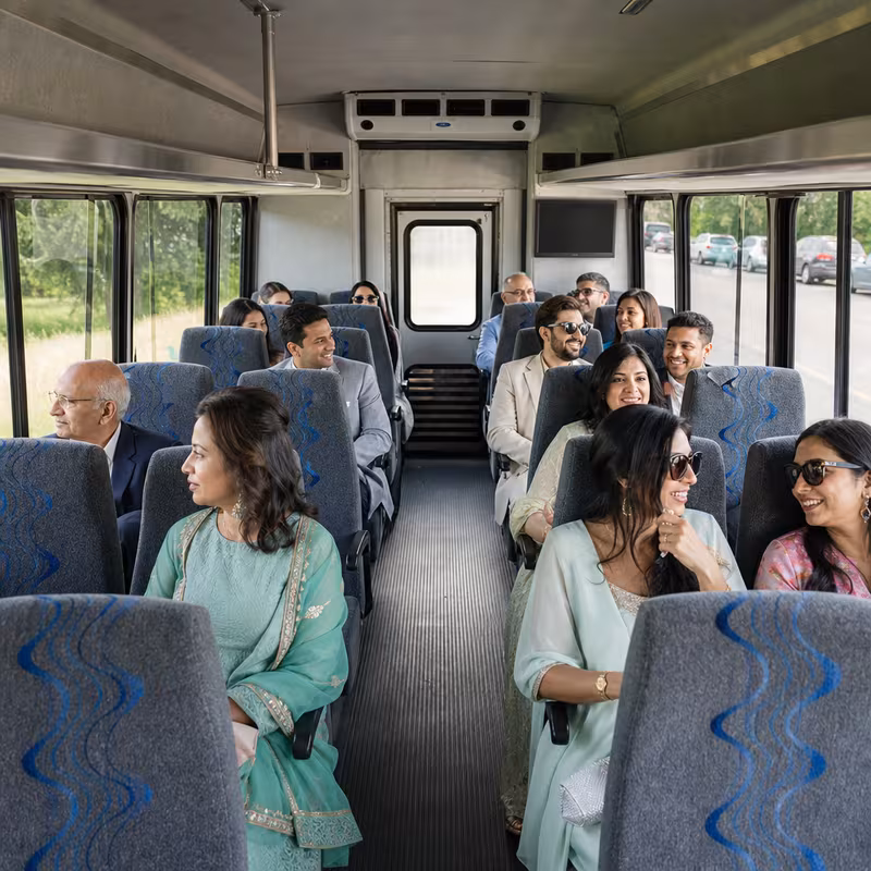 Group boarding a white charter bus for Private Event Transportation transportation in McKinney