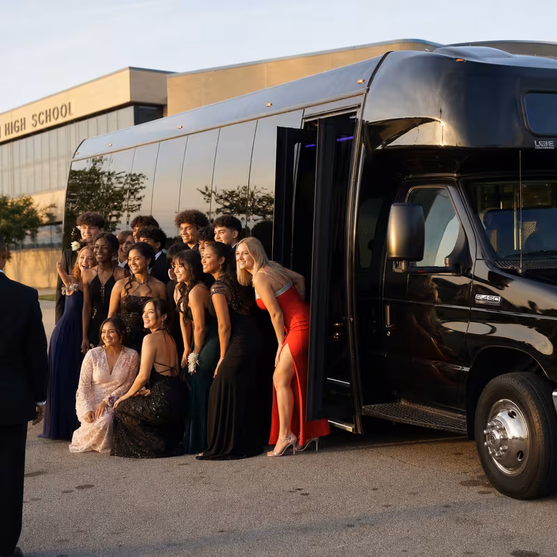 Group boarding a white charter bus for Prom & Homecoming Transportation transportation in McKinney