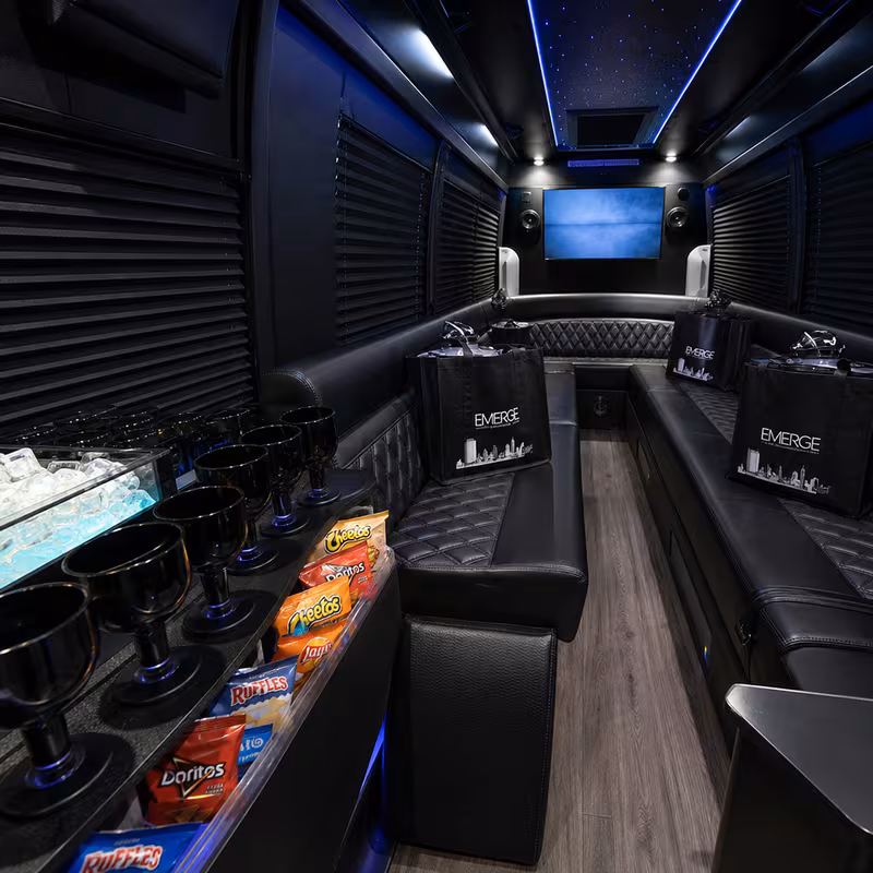 Party bus interior with wraparound leather seating and LED lighting in McKinney